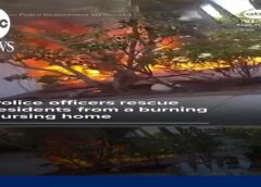 Police officers rescue residents from a burning nursing home